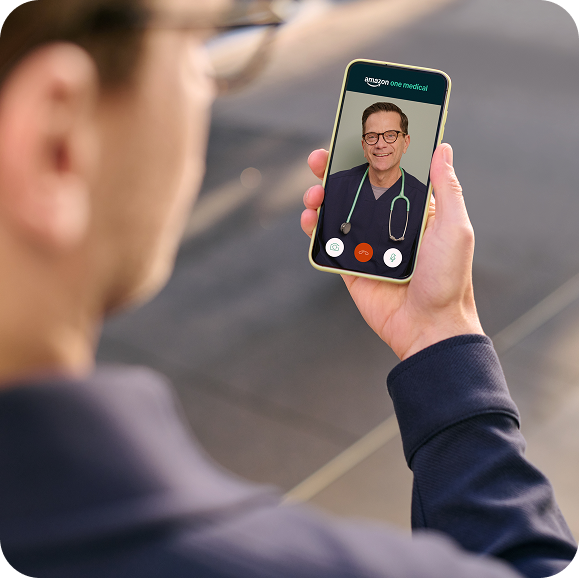 A member on a One Medical video visit with a clinician, on their phone